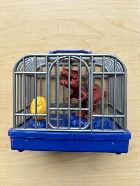 ABC Trading toy recall image showing electronic dinosaur toy cage with red dinosaur