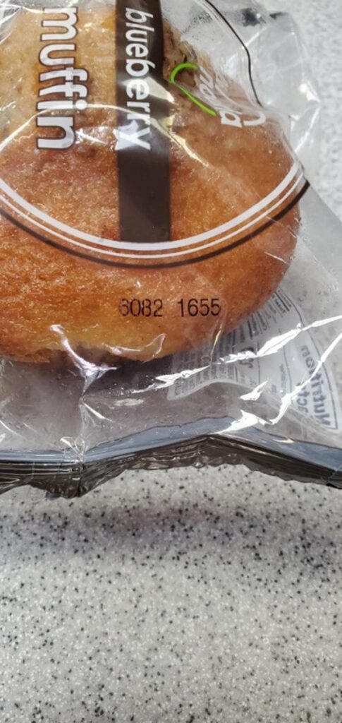 Close-up image of recalled Nouria blueberry muffin showing printed product code associated with walnut allergy recall.