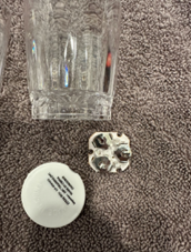 Battery compartment on recalled WSDZ light-up shot glass showing three button cell batteries